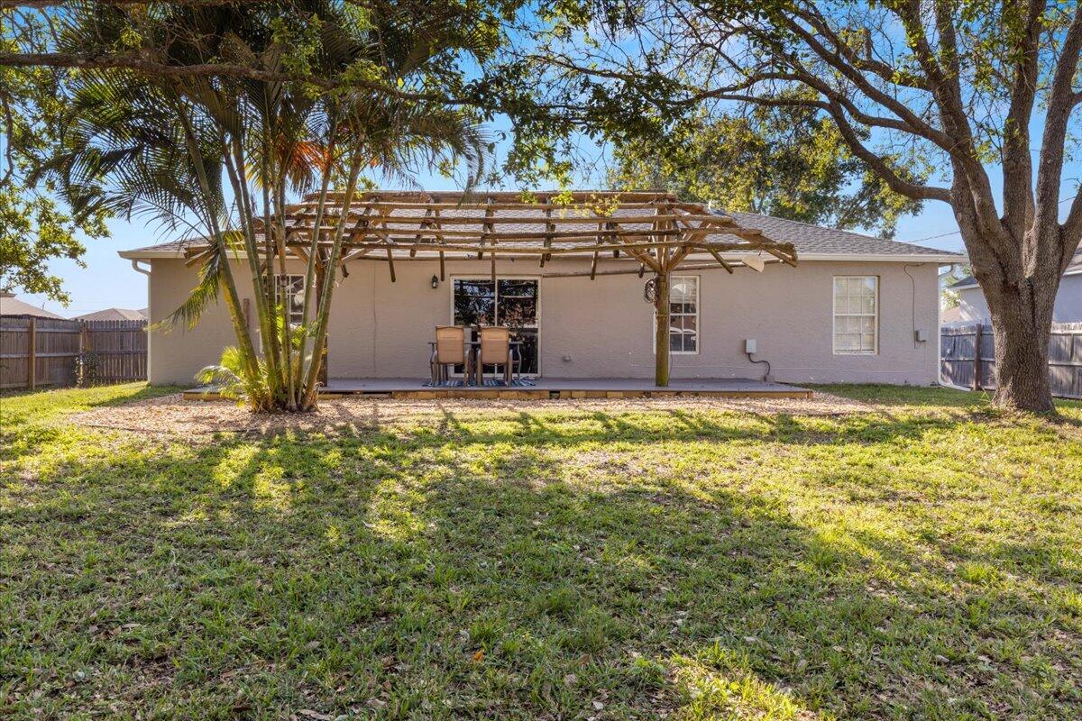4243 Southwest Utterback Street Port St. Lucie, FL 34953 - Photo 15 of 28 a view of a house with yard and tree