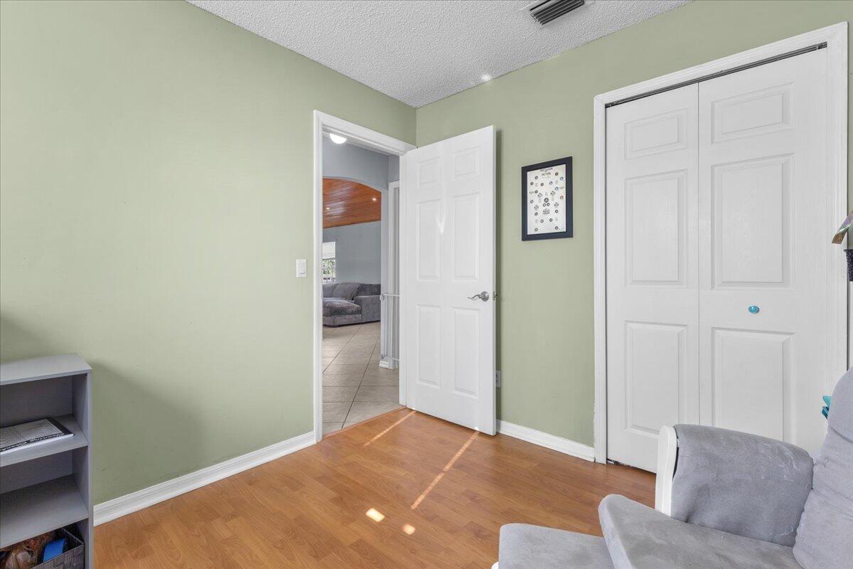 4243 Southwest Utterback Street Port St. Lucie, FL 34953 - Photo 19 of 28 a view of livingroom with furniture and closet