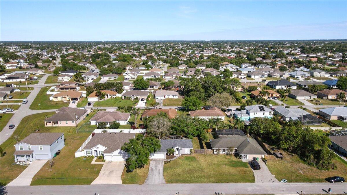 4243 Southwest Utterback Street Port St. Lucie, FL 34953 - Photo 25 of 28 an aerial view of residential houses with outdoor space