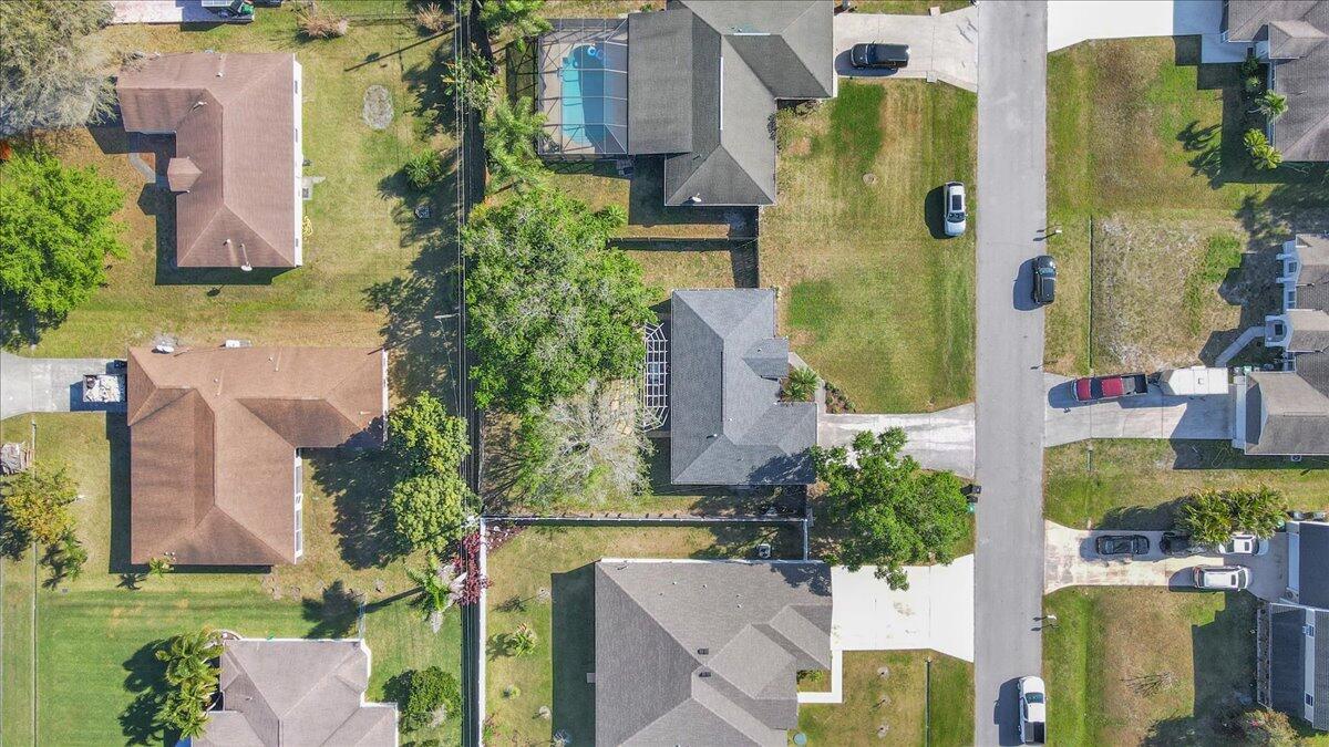 4243 Southwest Utterback Street Port St. Lucie, FL 34953 - Photo 26 of 28 aerial view of multiple houses with a yard