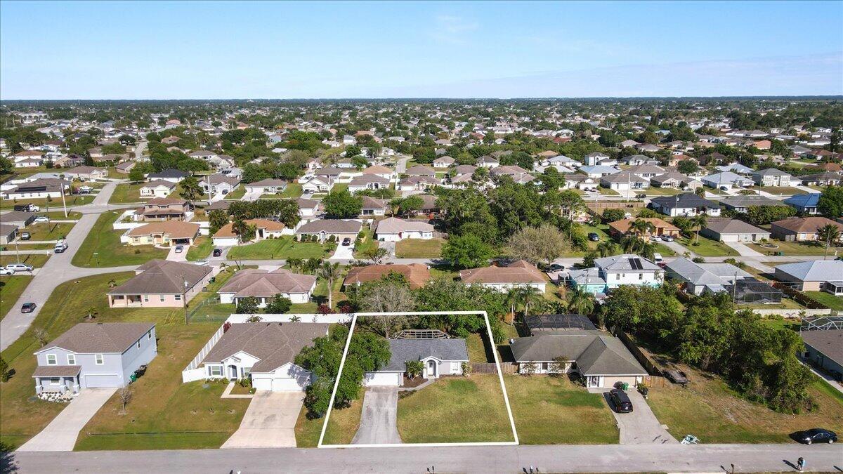 4243 Southwest Utterback Street Port St. Lucie, FL 34953 - Photo 28 of 28 an aerial view of residential houses with outdoor space