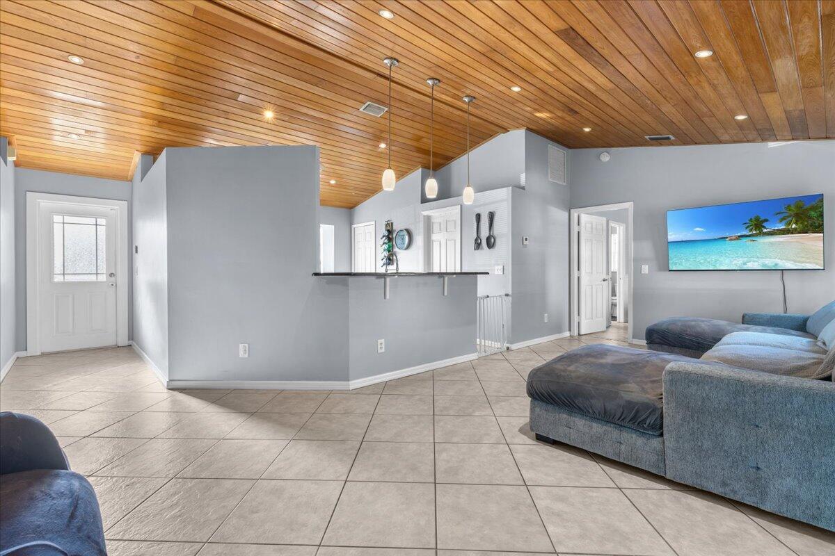 4243 Southwest Utterback Street Port St. Lucie, FL 34953 - Photo 5 of 28 a bedroom with furniture and a rug