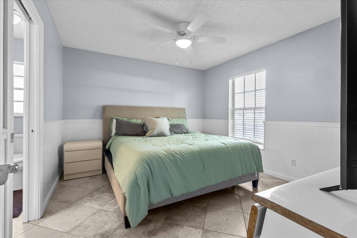 4243 Southwest Utterback Street Port St. Lucie, FL 34953 - Photo 10 of 28 a bedroom with a bed and a window