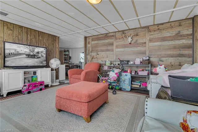 a bedroom with furniture and a flat screen tv