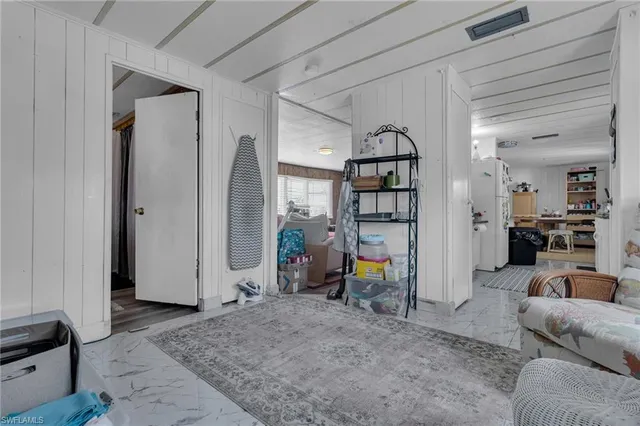 a view of a livingroom with furniture and a hallway