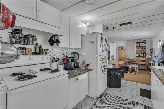 a kitchen with sink cabinets and appliances