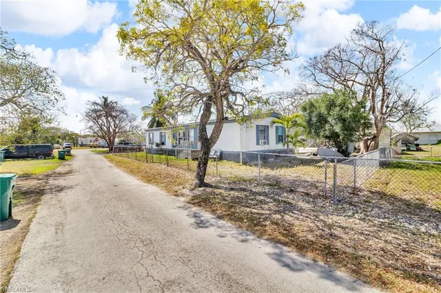 a view of yard with swimming pool and trees