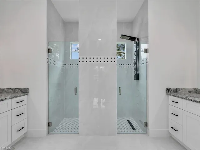 a bathroom with a granite countertop sink a shower and a mirror