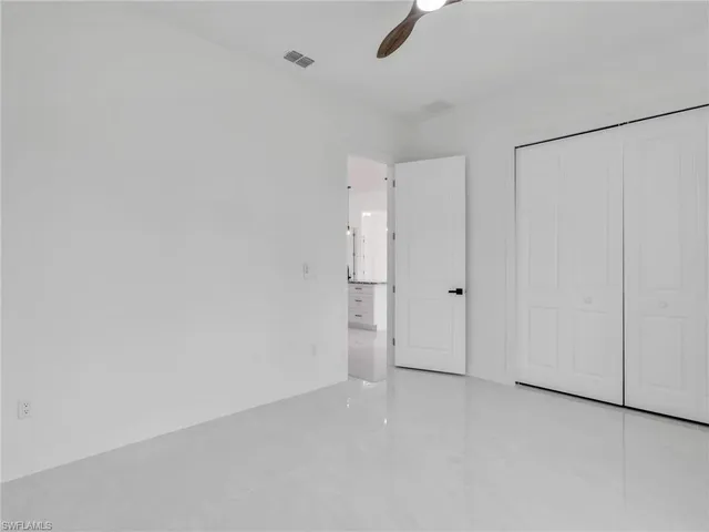 a bathroom with a granite countertop sink toilet a mirror a vanity and shower