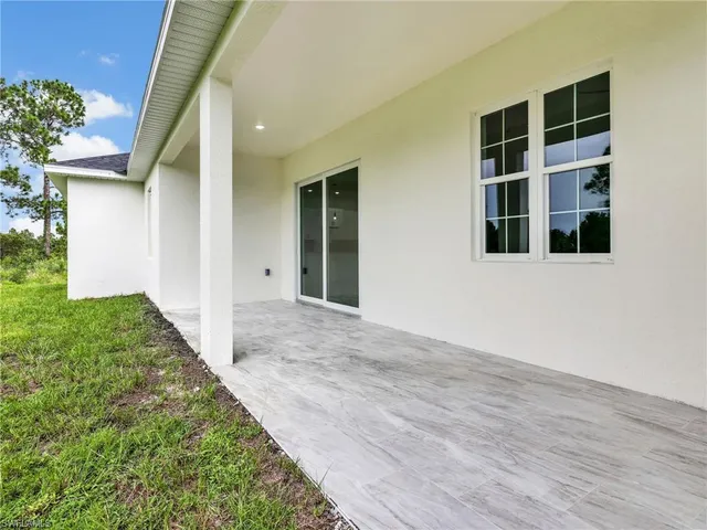 a view of a garden with a building in the background