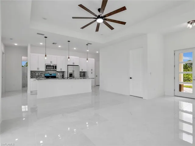 a view of kitchen with refrigerator and window