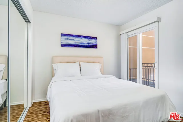 a bedroom with a large bed and a window