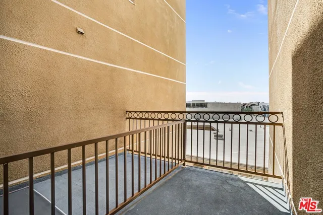 a view of a balcony with a small yard