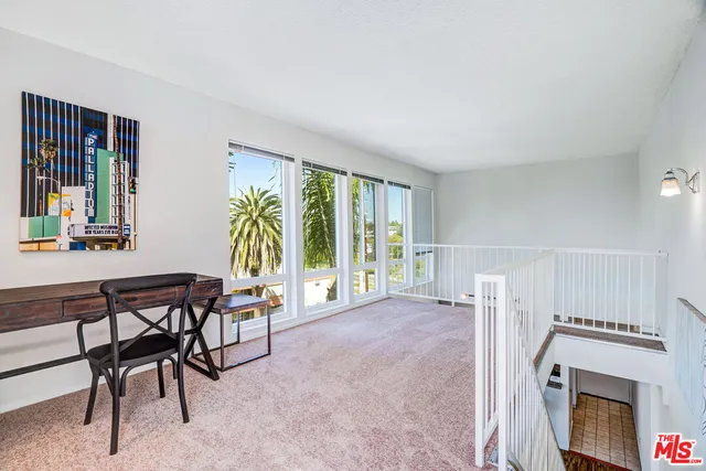 a view of a livingroom with furniture and a window