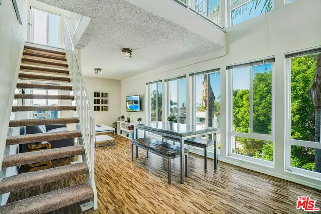 a living room with furniture and a floor to ceiling window