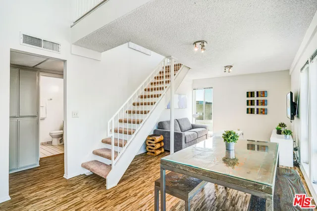 a view of an empty room and wooden floor