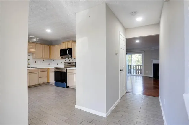 a view of a kitchen with cabinets and wooden floor