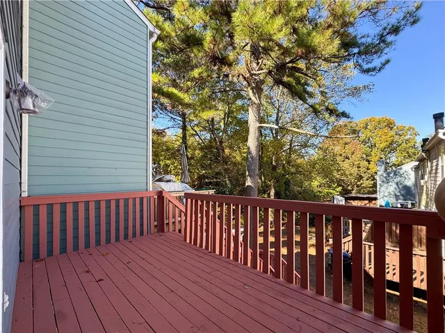 a balcony with wooden floor and fence