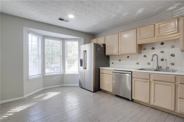 a kitchen with granite countertop white cabinets and white appliances