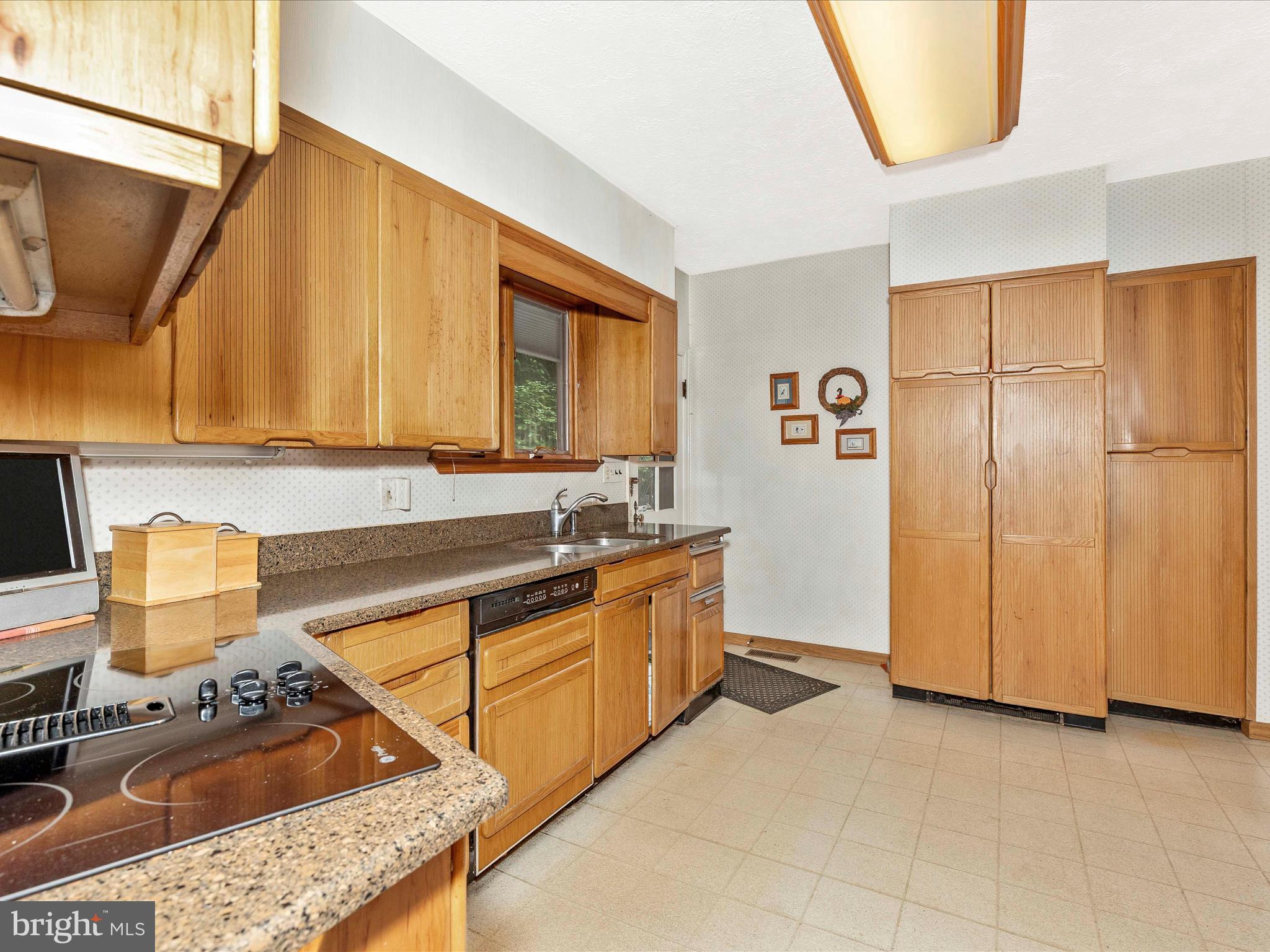 5100 Brook Green Road Baltimore, MD 21229 - Photo 11 of 54 a kitchen with stainless steel appliances granite countertop a sink stove and refrigerator