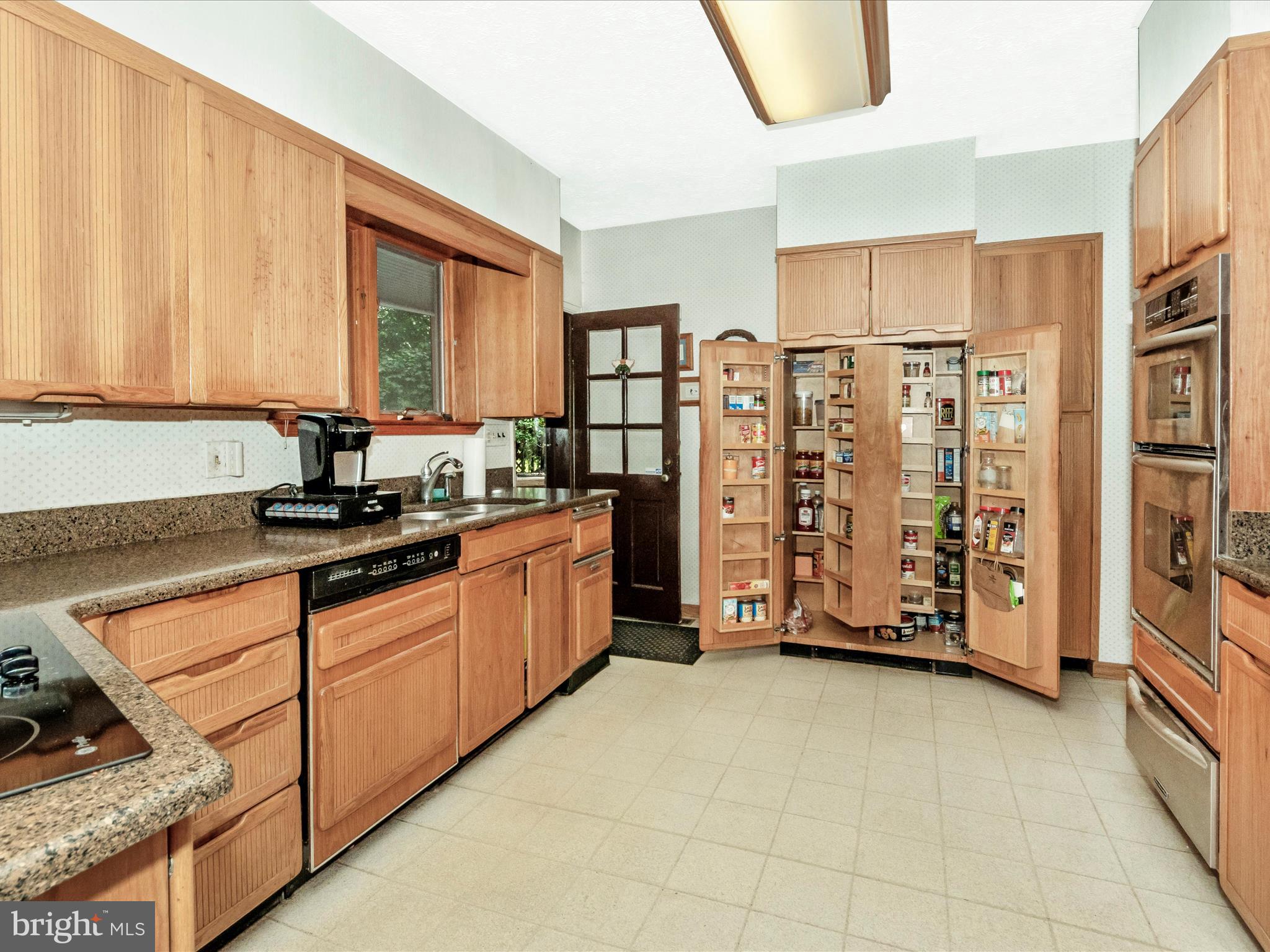 5100 Brook Green Road Baltimore, MD 21229 - Photo 13 of 54 a kitchen with stainless steel appliances granite countertop a stove a sink and a refrigerator