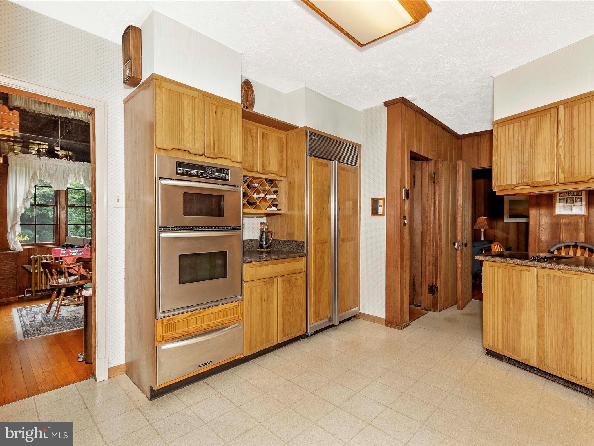 5100 Brook Green Road Baltimore, MD 21229 - Photo 15 of 54 a kitchen with stainless steel appliances a refrigerator and a stove