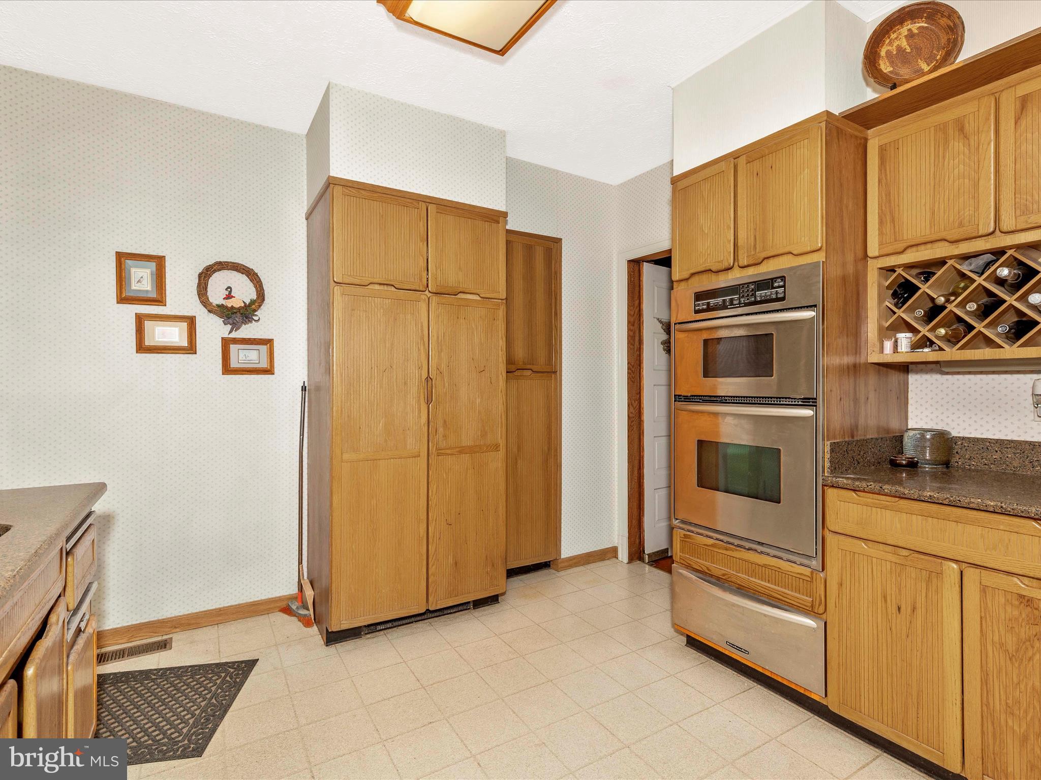 5100 Brook Green Road Baltimore, MD 21229 - Photo 16 of 54 a kitchen with stainless steel appliances granite countertop a refrigerator and a stove top oven