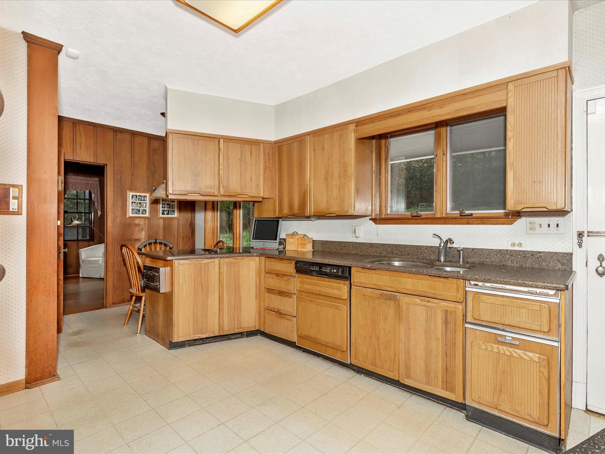 5100 Brook Green Road Baltimore, MD 21229 - Photo 17 of 54 a kitchen with granite countertop white cabinets and stainless steel appliances