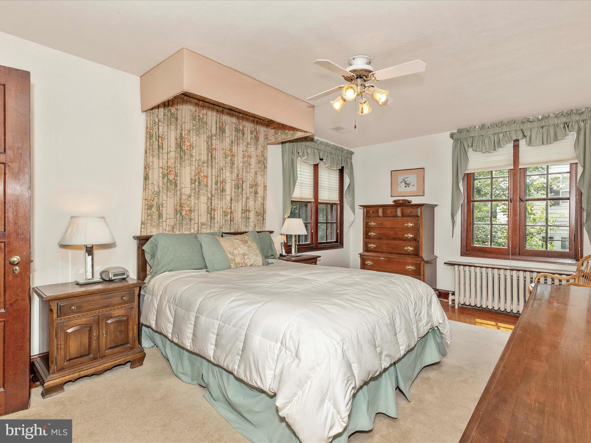 5100 Brook Green Road Baltimore, MD 21229 - Photo 24 of 54 a bedroom with a bed and a chandelier