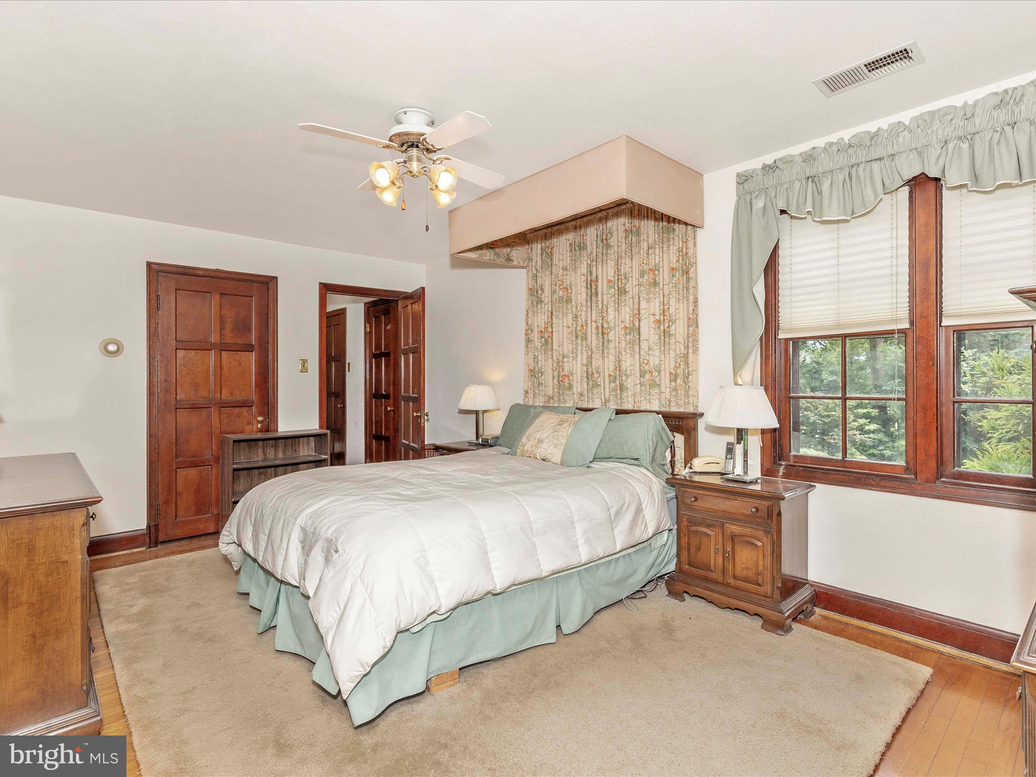 5100 Brook Green Road Baltimore, MD 21229 - Photo 25 of 54 a bedroom with a large bed and a chandelier