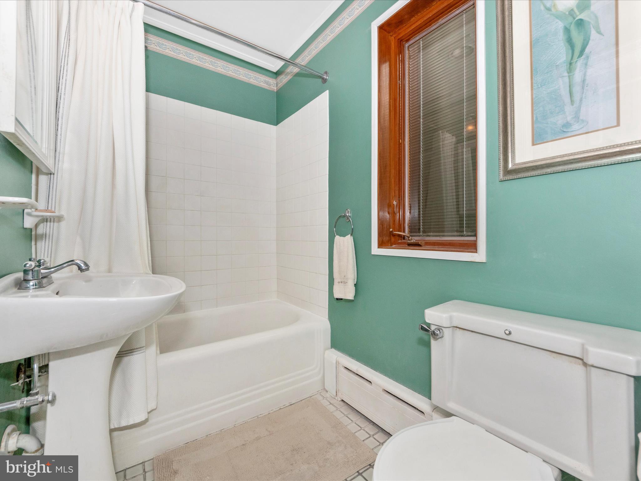 5100 Brook Green Road Baltimore, MD 21229 - Photo 26 of 54 a bathroom with a sink a toilet and shower