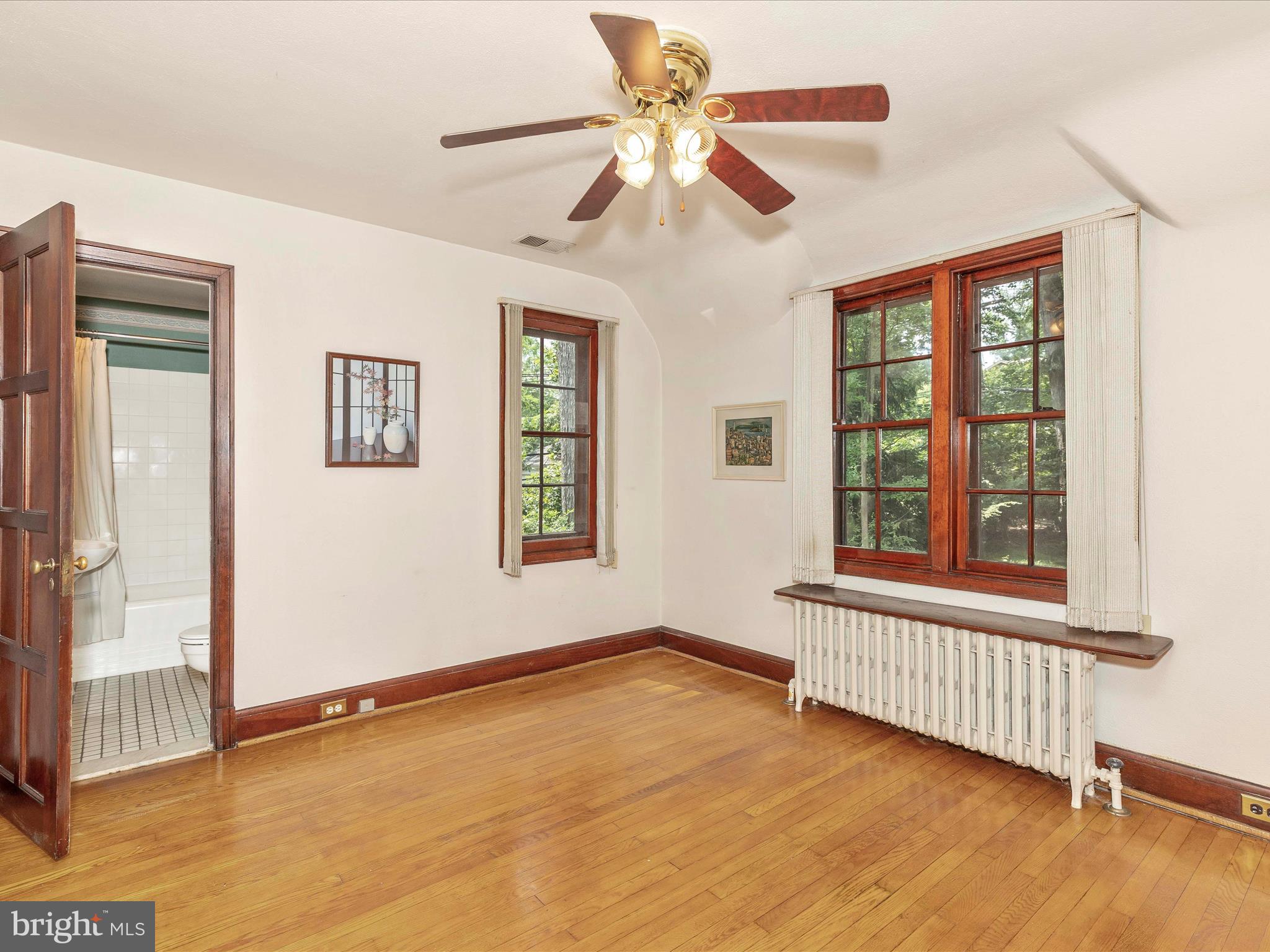 5100 Brook Green Road Baltimore, MD 21229 - Photo 28 of 54 a view of an empty room with a window and wooden floor