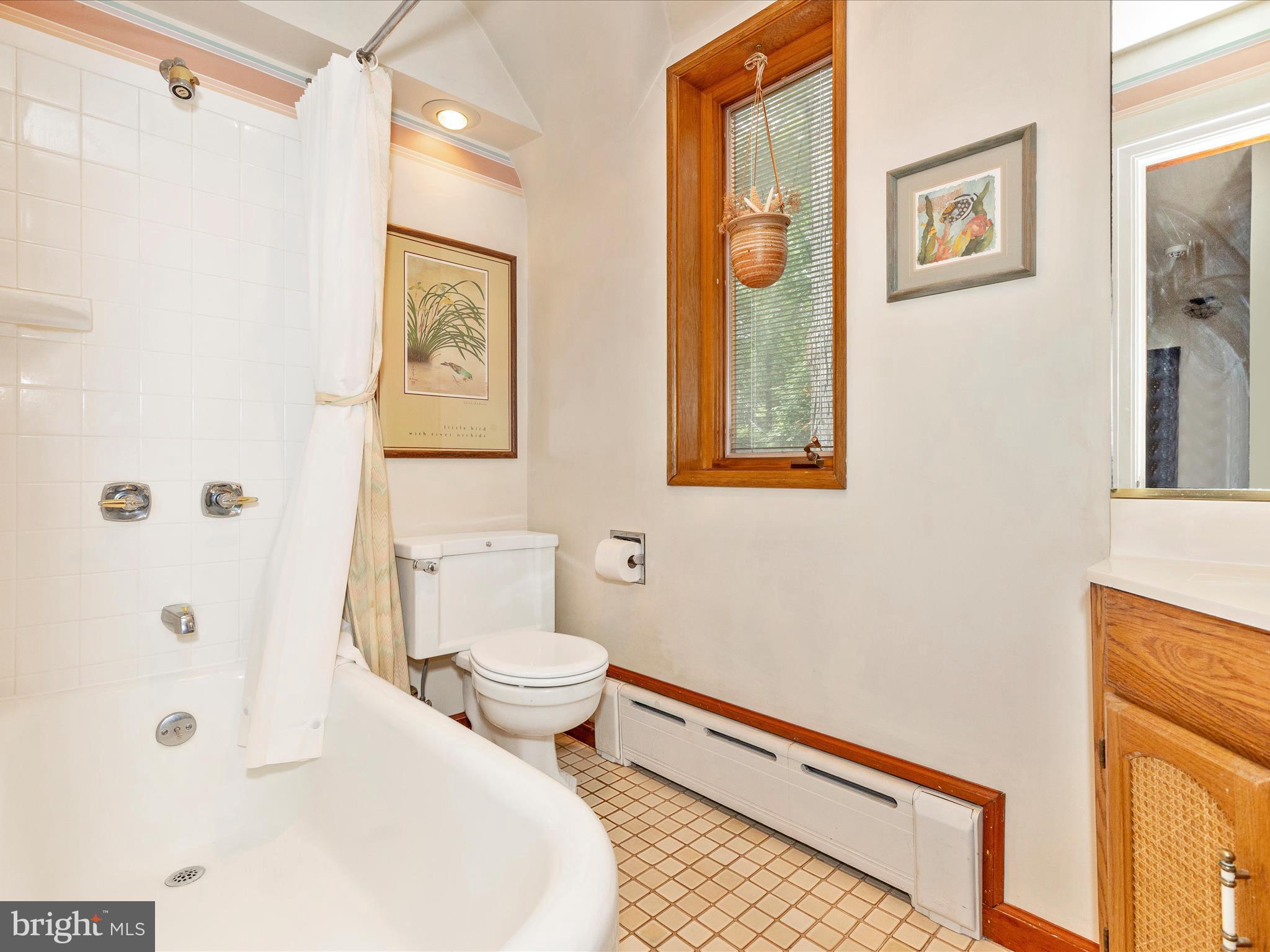 5100 Brook Green Road Baltimore, MD 21229 - Photo 34 of 54 a bathroom with a toilet a sink and glass door