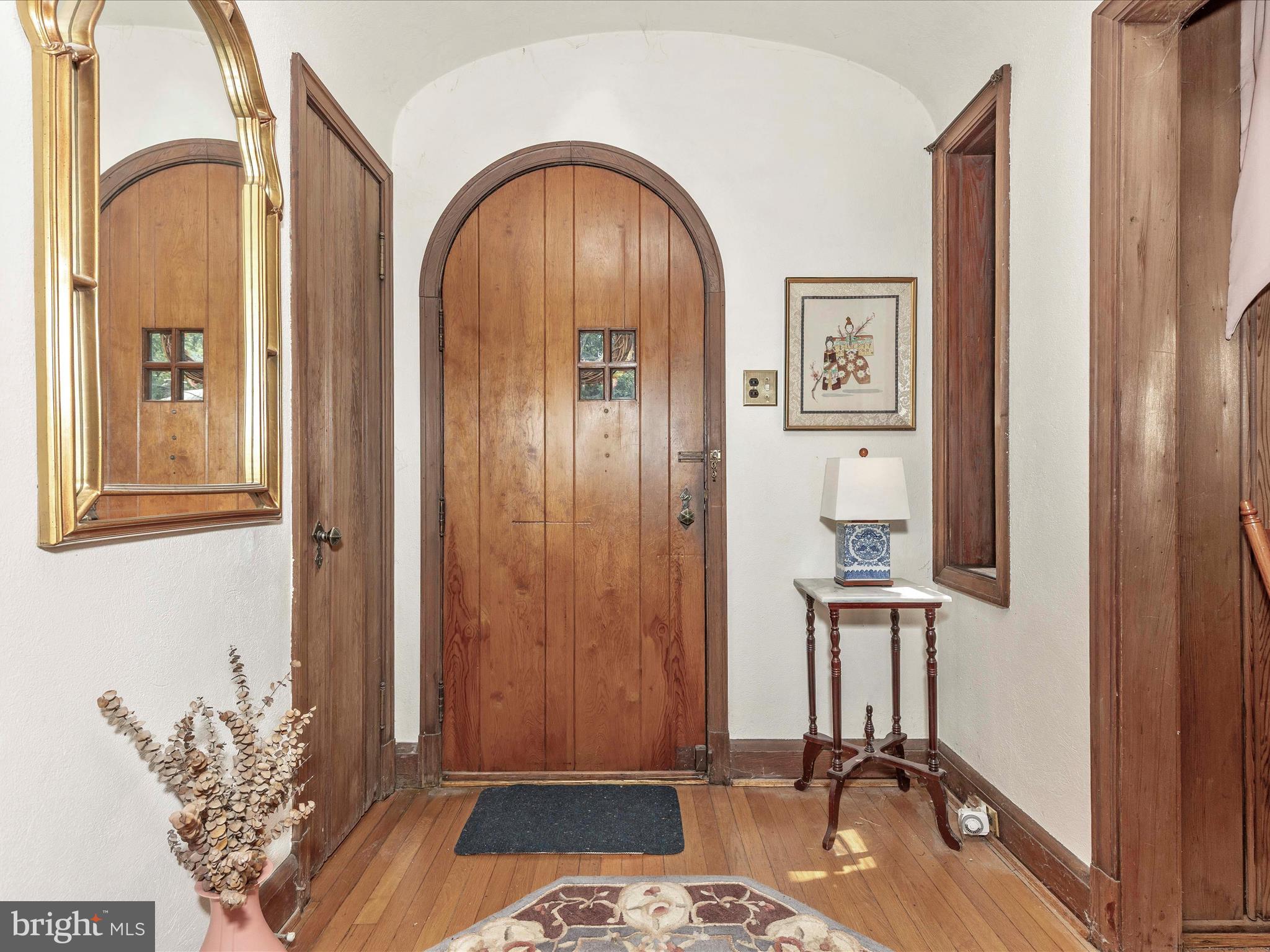 5100 Brook Green Road Baltimore, MD 21229 - Photo 4 of 54 a front view of a house with wooden floor and a potted plant