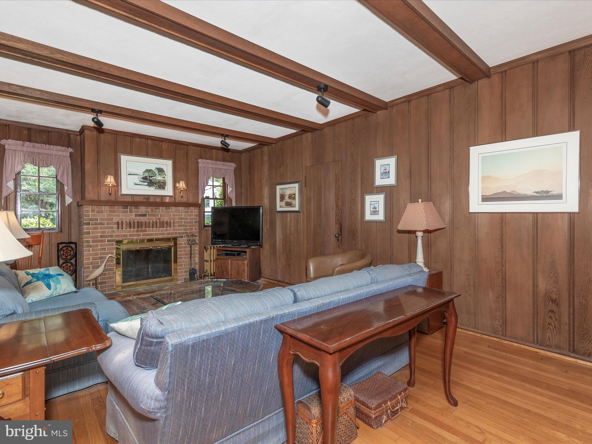 5100 Brook Green Road Baltimore, MD 21229 - Photo 7 of 54 a living room with furniture a fireplace and a flat screen tv