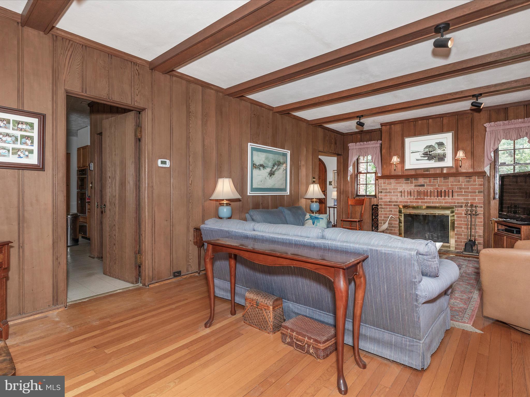 5100 Brook Green Road Baltimore, MD 21229 - Photo 8 of 54 a living room with furniture a fireplace and a table
