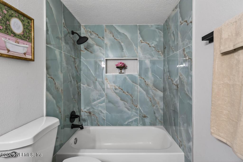 43739 Ratliff Road Callahan, FL 32011 - Photo 37 of 55 a bath tub sitting next to a white toilet and sink