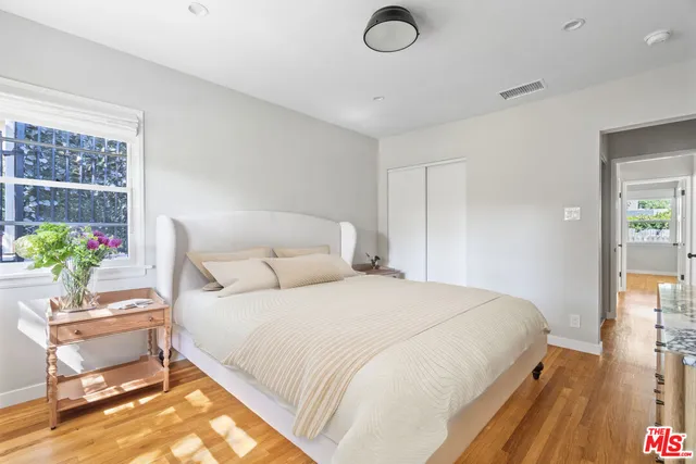 a bedroom with a bed and a potted plant