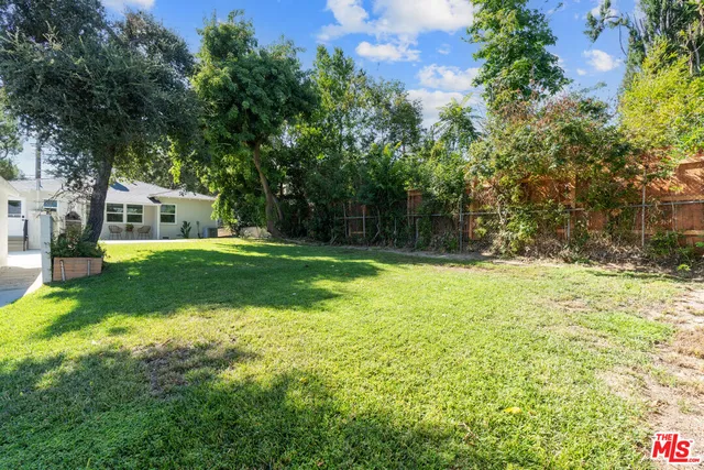 a swimming pool with trees in the background
