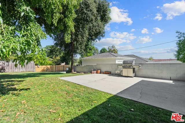 a view of a house with yard and a garden