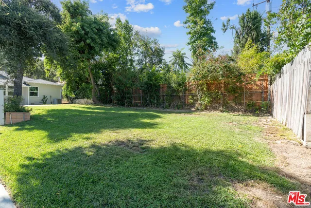 a backyard of a house with swimming pool and green space