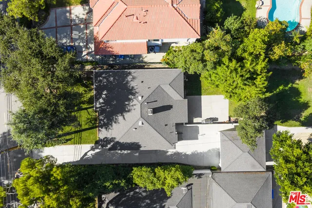 an aerial view of a house with a yard