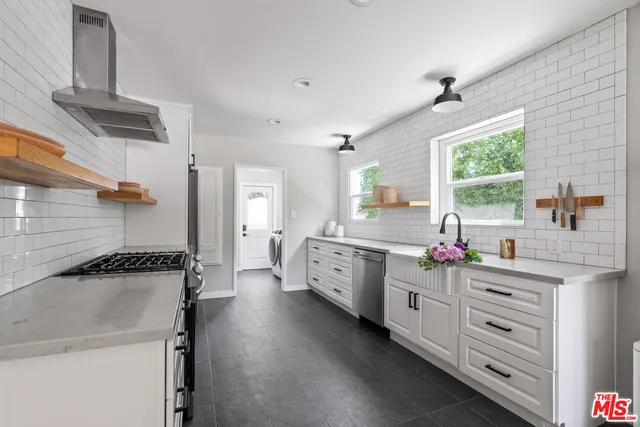 a kitchen with a stove a refrigerator and a sink