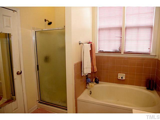 3204 Sedgefield Pines Lane Raleigh, NC 27604 - Photo 13 of 20 a bathroom with a tub shower and a window