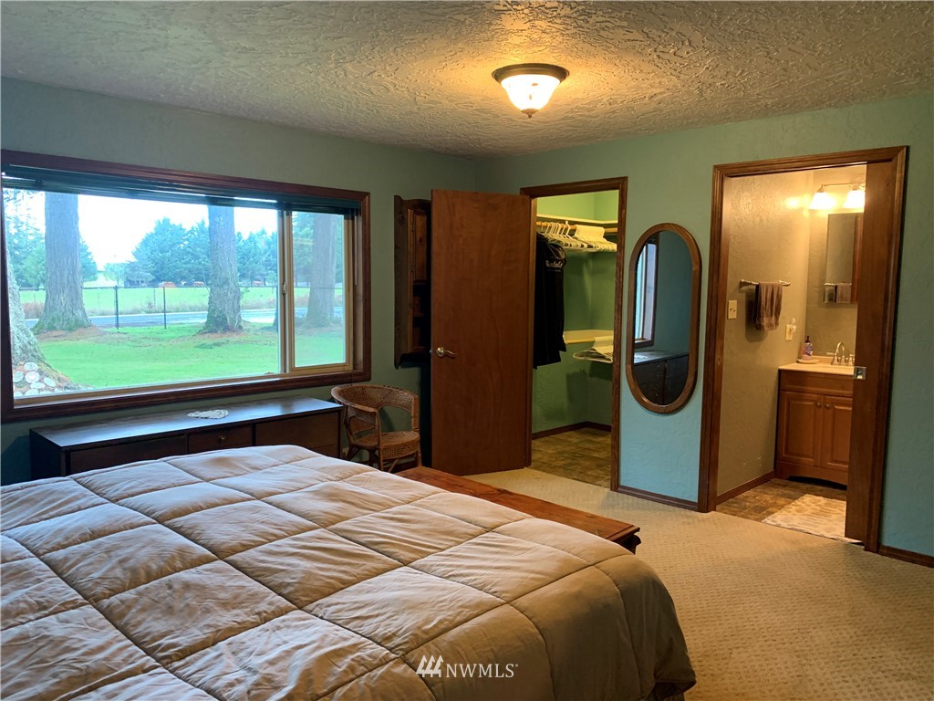106 Pattee Road Chehalis, WA 98532 - Photo 13 of 33 a bedroom with a bed and glass door