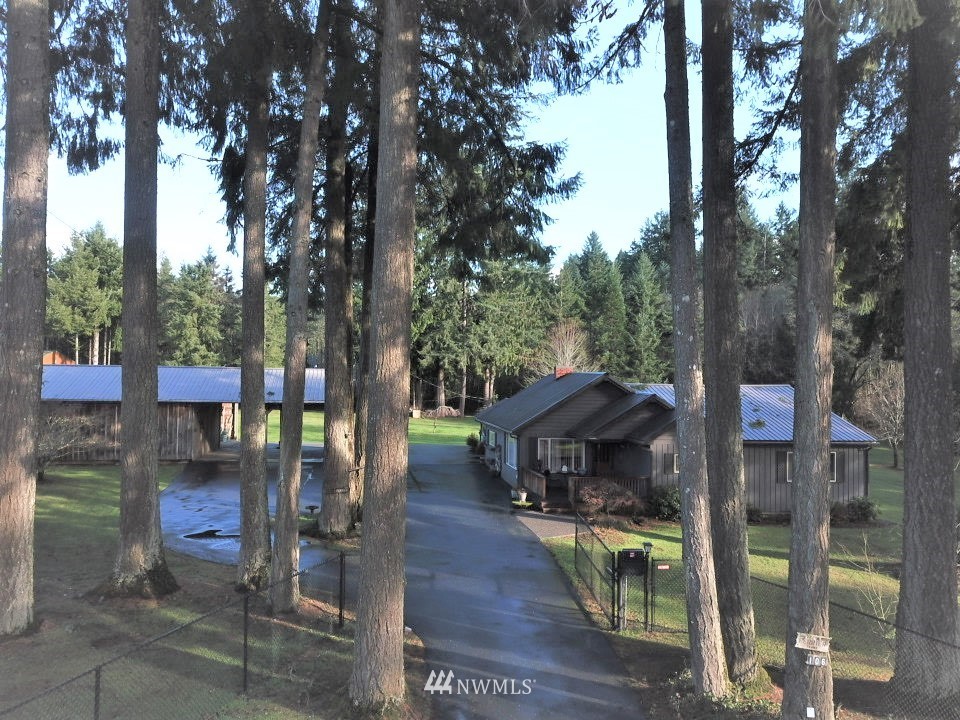 106 Pattee Road Chehalis, WA 98532 - Photo 2 of 33 a small garden covered with tall trees