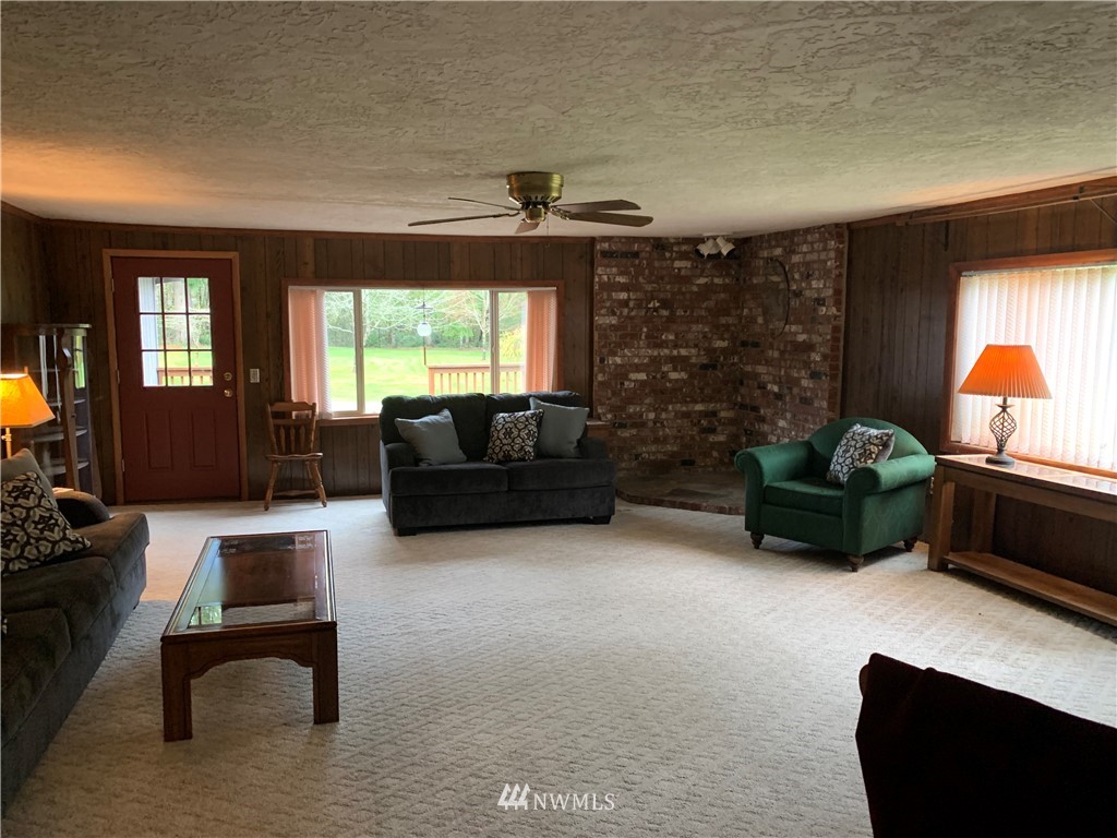 106 Pattee Road Chehalis, WA 98532 - Photo 10 of 33 a living room with furniture a window and a fireplace