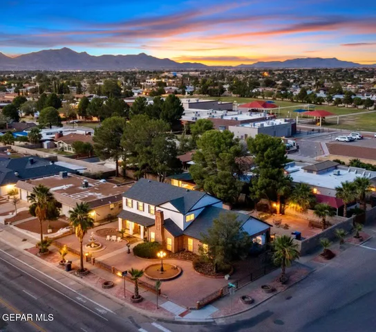 a backyard of a house with table and chairs
