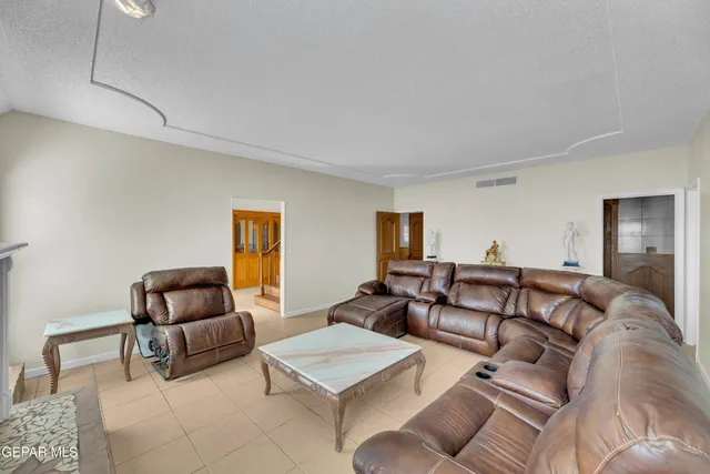 a spacious bathroom with a tub and checkered floor