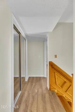 a view of a room with wooden floor and a sink
